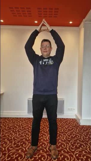 Praticien toujours bras levés, sommet du triangle formé, posture stable et immobile